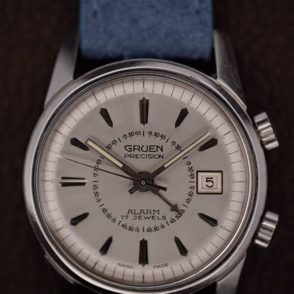Gruen Precision Alarm dial close-up showing the inner alarm scale, date window and both case crowns