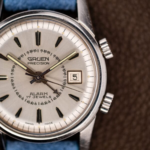 Gruen Precision Alarm 950CA silver dial and knurled twin crowns seen from the right side