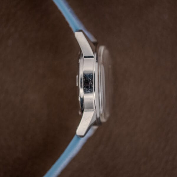 Gruen 950CA stainless case flank with faceted lugs, brushed lug tops and a raised domed crystal