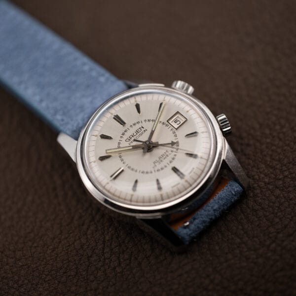 Silver sunburst Gruen alarm dial with dual crowns, faceted applied markers and aged lume in the hands