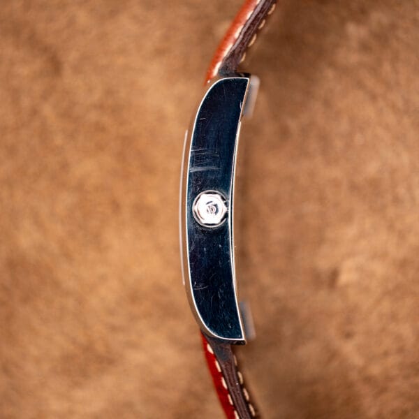 Signed crown on the polished flank of the Baume Mercier Hampton MV045120 stainless steel case