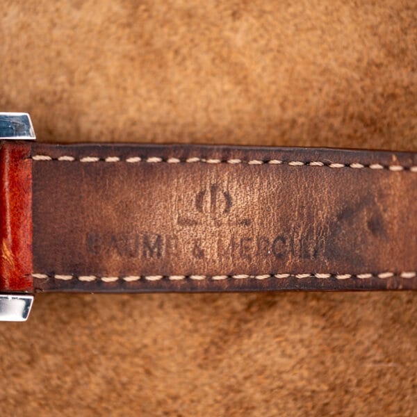 Underside of the brown leather strap on the Baume Mercier Hampton MV045120 showing faded 18mm stamp