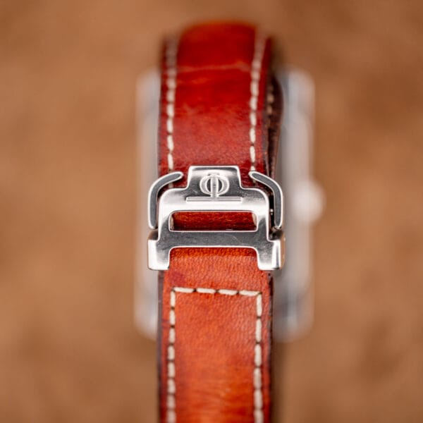Polished folding clasp and brown leather strap detail on the Baume Mercier Hampton MV045120