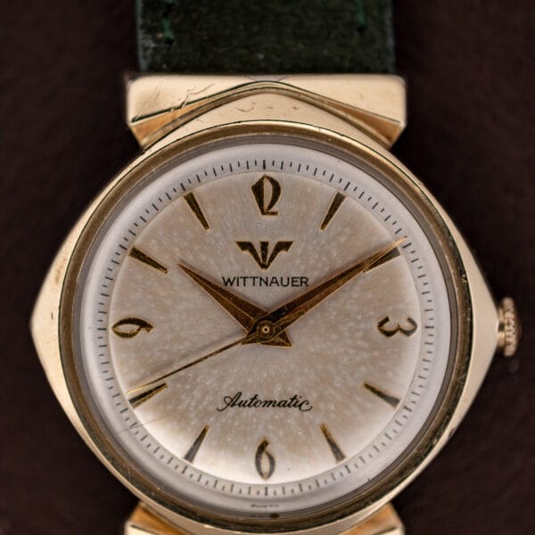 Silver dial macro on the Wittnauer 2598-1 showing applied gold markers, dauphine hands and mottled age patina