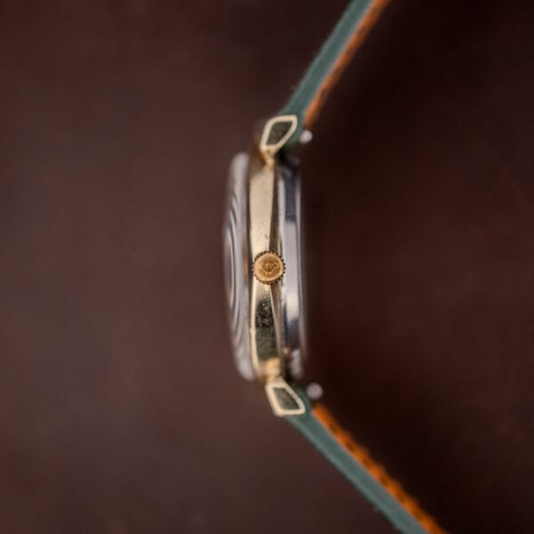 Wittnauer 2598-1 side profile showing the hooded lug arch over the strap end and the crown