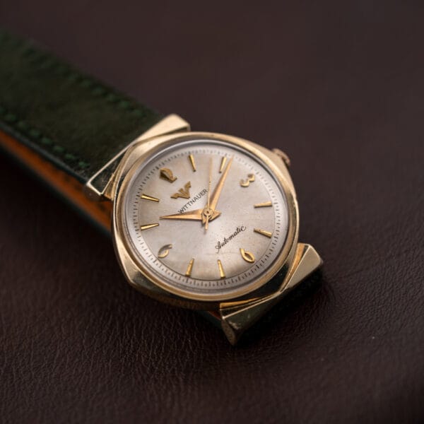 Wittnauer Automatic at an angle, center seconds hand sitting slightly bent near the pinion