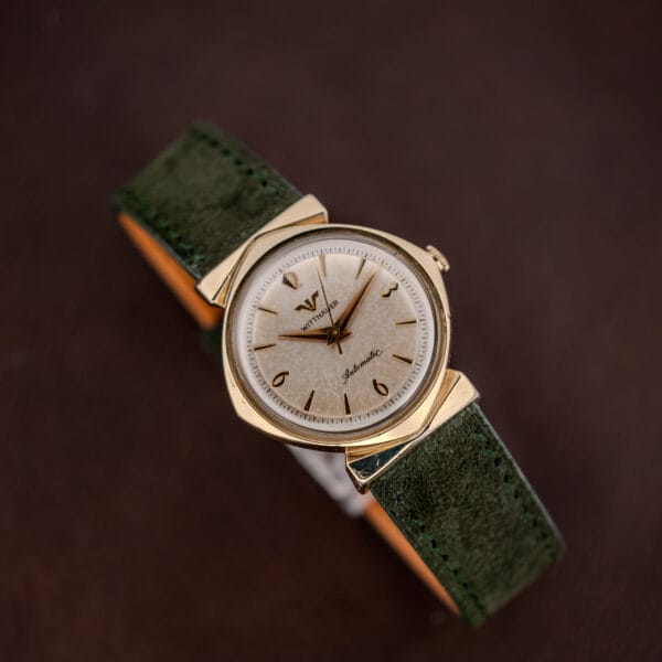 Vintage Wittnauer automatic watch with textured silver dial, gold filled hooded lug case and green suede strap