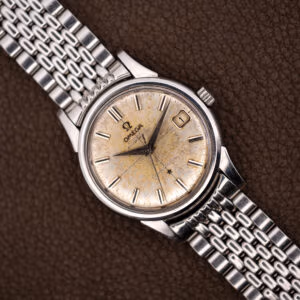 Omega Constellation 14393 with heavily patinated off-white dial and date at three on a steel bracelet