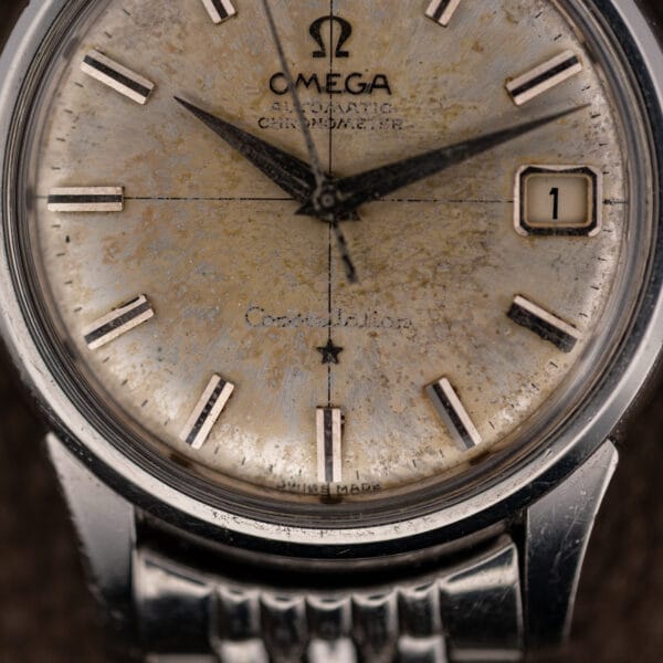 Patinated Constellation 14393 dial with framed date window at three and faded Constellation script above SWISS MADE