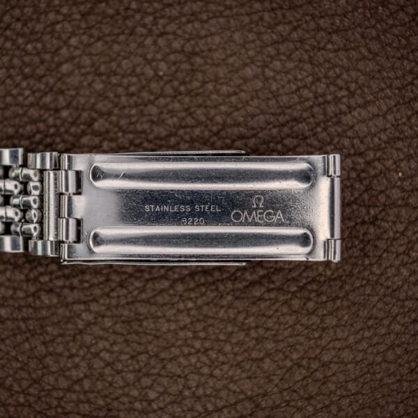 Omega bracelet clasp interior stamped OMEGA, STAINLESS STEEL and 8220, scuffed from years of opening