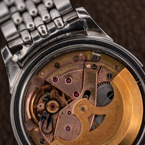 Omega caliber 561 movement with gold-toned rotor, serial number 19049603 and the Omega caliber marking visible