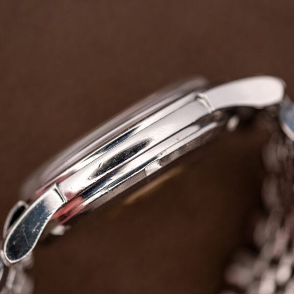 Macro side view of the Omega 14393 case flank showing polishing softness and fine scratches