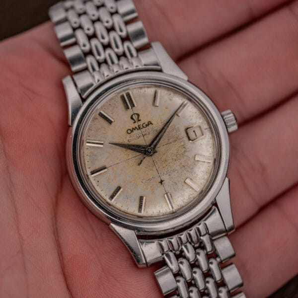 Omega Constellation 14393 with mottled patina across the dial on its later steel bracelet