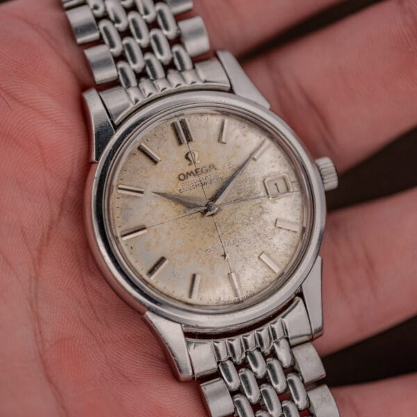Close front view of the Omega Constellation 14393 showing date at three and darkened central seconds hand