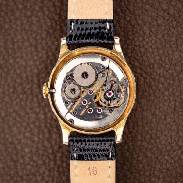Benrus Model CE-13 movement in the opened gold-tone case, marked SEVENTEEN 17 JEWELS and BENRUS WATCH CO.