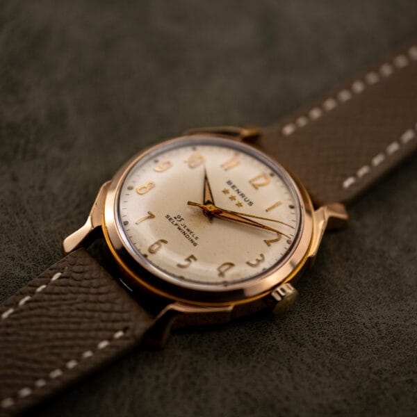 Oblique view of Benrus 3 Star 7155 dial under a domed acrylic crystal, gold electroplate bezel