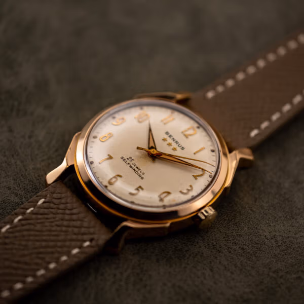 Oblique view of Benrus 3 Star 7155 dial under a domed acrylic crystal, gold electroplate bezel