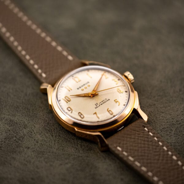 Vintage Benrus automatic angled on taupe Saffiano leather strap, cream dial catching the studio light