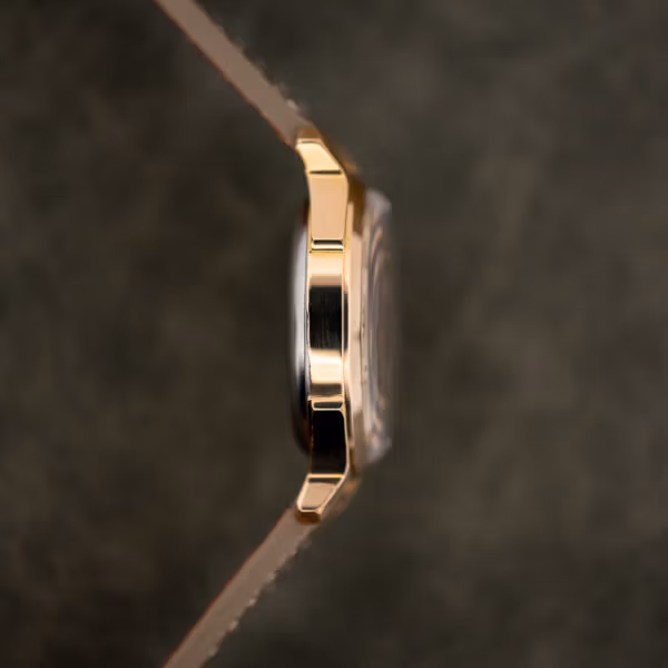 Side view of the Benrus 7155 gold electroplate case, domed crystal edge and taupe leather strap