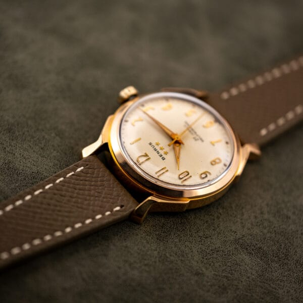 Angled close view of the Benrus 3 Star 7155, cream dial and polished gold electroplate case