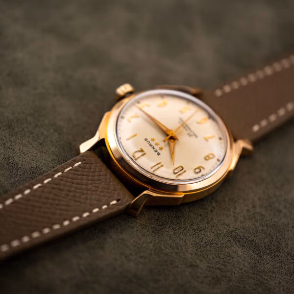 Angled close view of the Benrus 3 Star 7155, cream dial and polished gold electroplate case
