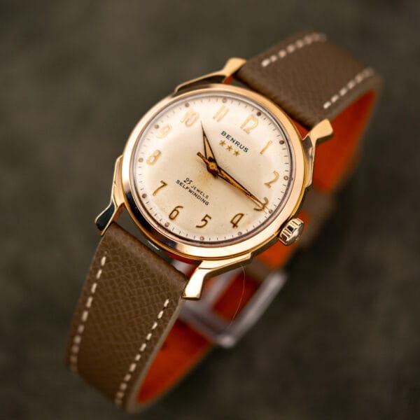 Cream dial of the Benrus Series 7155 with applied gold Arabic numerals and darkened hour plots
