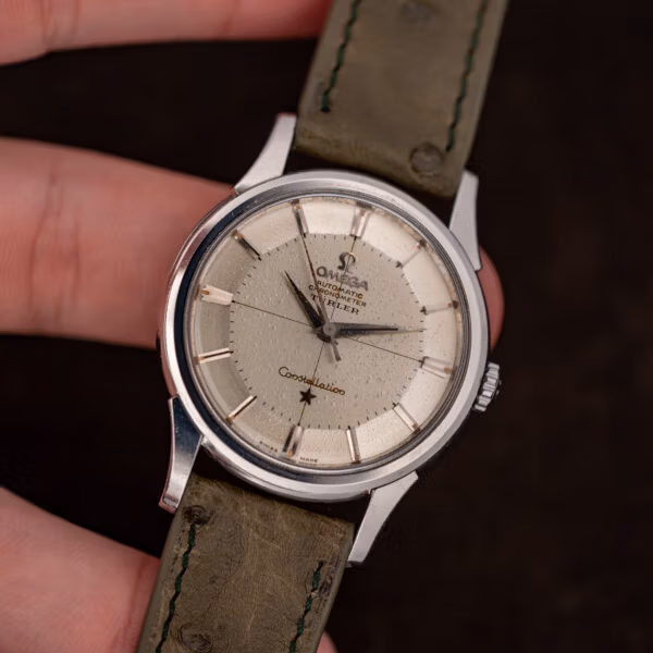 Omega Constellation 14381-7 front view, heavily speckled off-white dial on olive ostrich leather strap