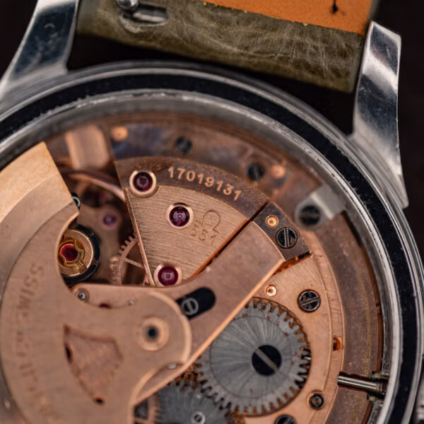 Omega calibre 551 movement macro showing serial 17019137 and the caliber marking beside jewelled bridges