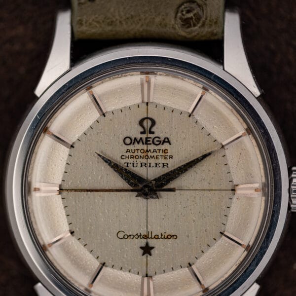 Omega Constellation 14381 dial macro showing the Türler signature, applied markers and heavy age speckling