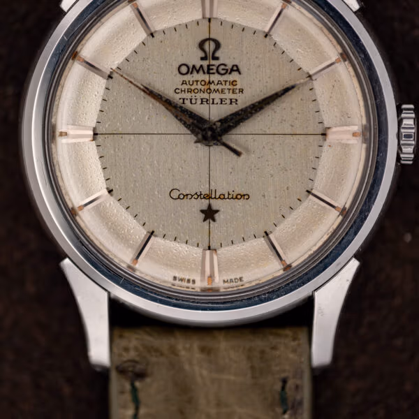 Türler-signed Omega Constellation pie-pan dial close-up with darkened dauphine hands and scratched crystal