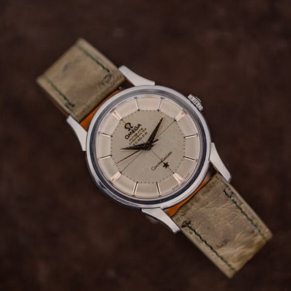 Omega Constellation 14381 pie-pan dial in even aged tone with scattered dark specks, on a worn olive strap
