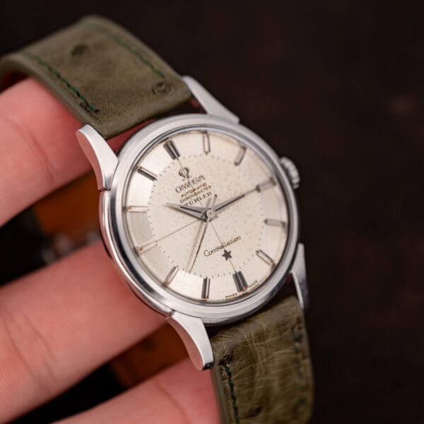 Türler-signed Omega Constellation held in hand, spotted dial patina and hazy acrylic crystal in close view