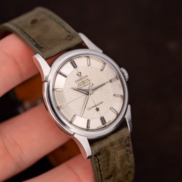 Türler-signed Omega Constellation held in hand, spotted dial patina and hazy acrylic crystal in close view