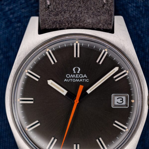 Omega Geneve 166.041 dial macro showing applied baton markers, aged cream lume plots and date window