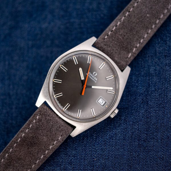 Omega Geneve 166.041 cushion steel case angled front, orange central seconds sweeping the brushed charcoal dial