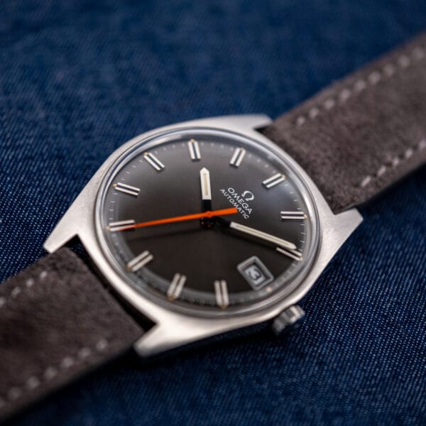 Omega Geneve 166.041 angled dial close-up with the date window at three beneath a domed crystal