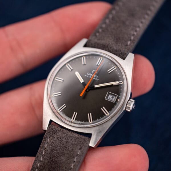 Omega 166.041 dial angled to show radial brushing catching light across the anthracite surface