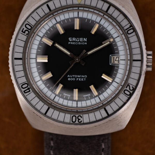 Vintage Gruen Autowind diver front view, black dial, date at three, wide bi-directional timing bezel