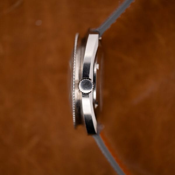 Gruen Autowind cushion case side profile with unsigned crown, domed crystal, and coin-edge bezel
