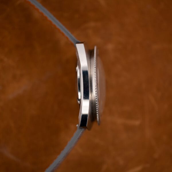 Gruen Precision Autowind stainless steel case flank and knurled bezel edge showing light hairline wear