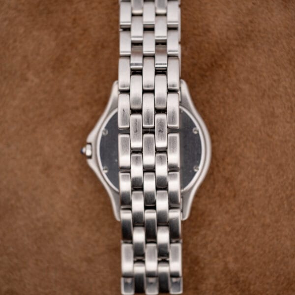 Rear three-quarter view of the Cartier Cougar with integrated five-link steel bracelet across the caseback