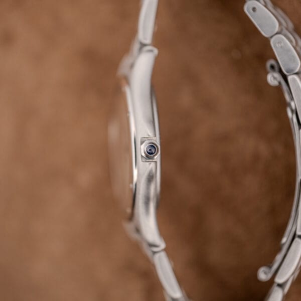 Side profile of the Cartier Cougar steel case showing the recessed crown and bracelet links