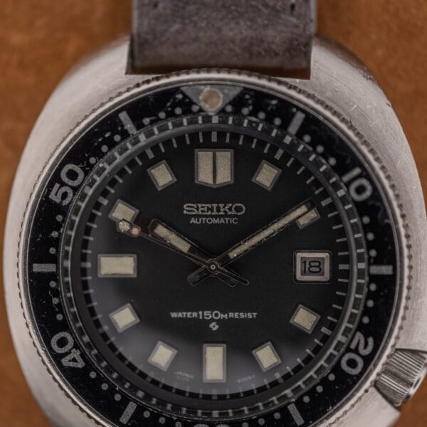 Seiko 6105 diver dial macro showing SEIKO AUTOMATIC, WATER 150m RESIST wording and the printed 6105-8009T code