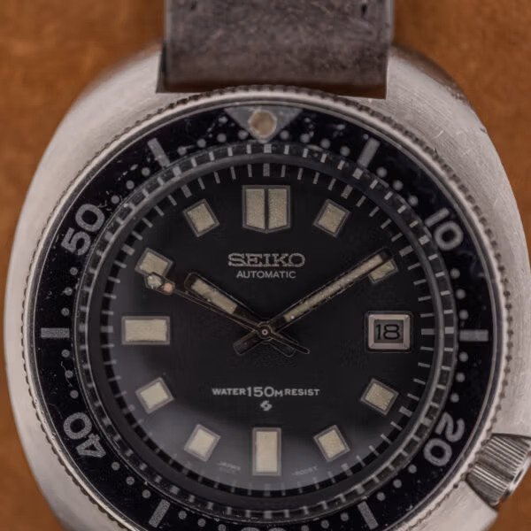 Seiko 6105 diver dial macro showing SEIKO AUTOMATIC, WATER 150m RESIST wording and the printed 6105-8009T code