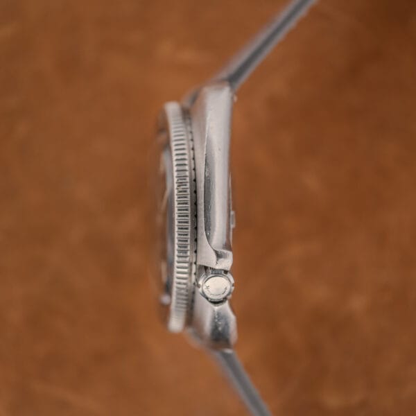 Crown side profile of the 6105-8119 showing the integrated crown guard shoulder and LOCK signed crown