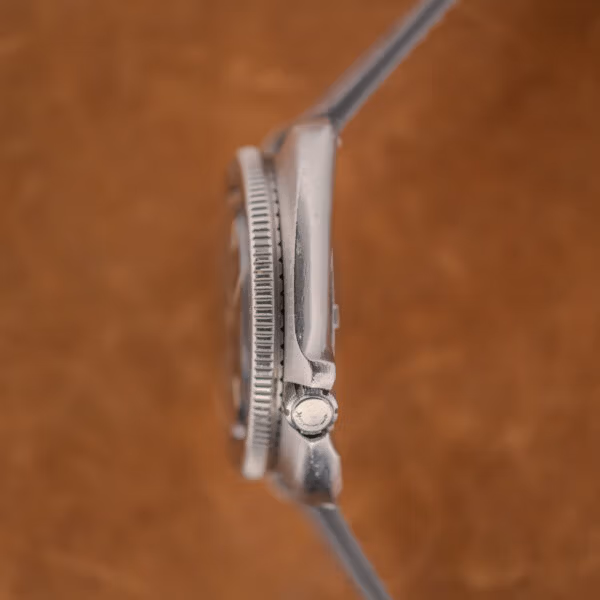 Crown side profile of the 6105-8119 showing the integrated crown guard shoulder and LOCK signed crown