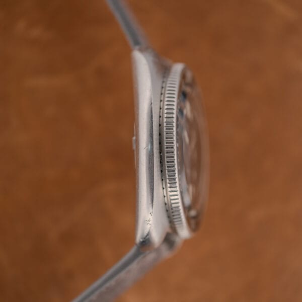 Seiko 6105-8119 case flank with serrated bezel edge, raised crystal and honest wear across the lower lug