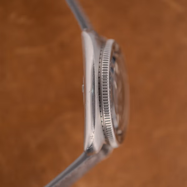 Seiko 6105-8119 case flank with serrated bezel edge, raised crystal and honest wear across the lower lug