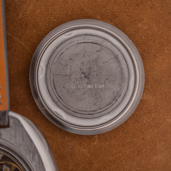 Interior of the Seiko 6105-8119 caseback stamped SEIKO TIME CORP. with heavy scratching across the center