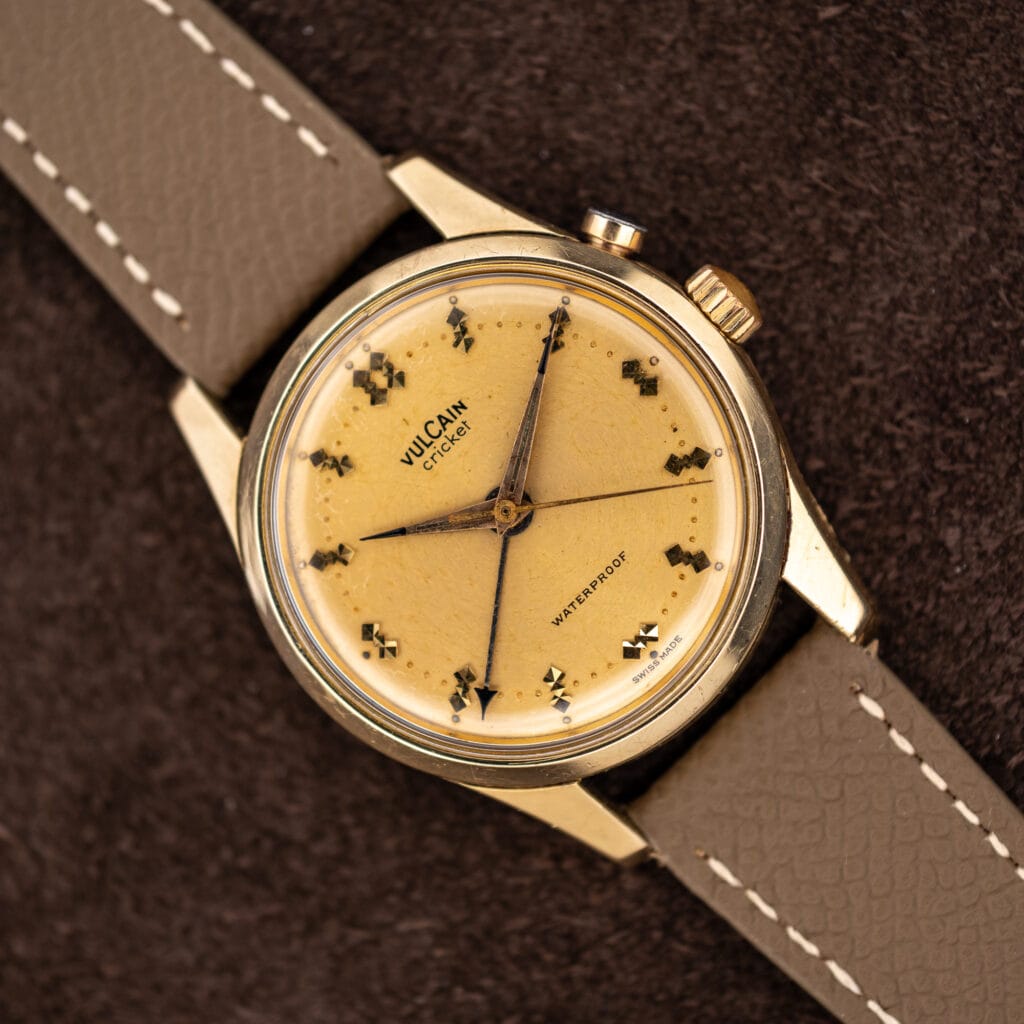 Vintage Vulcain Cricket 307004 alarm wristwatch, champagne dial with warm patina, on taupe leather strap
